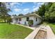 Quaint single-story home with lush landscaping and well-kept lawn at 1125 Josephine St, Lakeland, FL 33815