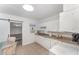 Practical kitchen space with white appliances, ample counter space, and a view to the living room at 1125 Josephine St, Lakeland, FL 33815