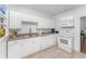 Well-lit kitchen featuring white cabinetry, laminate countertops, and a stainless steel sink at 1125 Josephine St, Lakeland, FL 33815