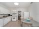 Bright eat-in kitchen featuring tiled floors, white appliances, and white cabinetry at 1125 Josephine St, Lakeland, FL 33815