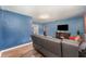 Comfortable living room with wood floors, TV, and a modern lighting fixture at 1125 Josephine St, Lakeland, FL 33815