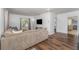 Comfortable living room with hardwood floors, a neutral colored sectional, and a modern television at 1125 Josephine St, Lakeland, FL 33815