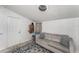 Bright living room features stylish blue patterned rug, and comfortable gray sofa with decorative pillows at 1125 Josephine St, Lakeland, FL 33815