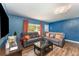 Inviting living room with wood floors, cozy seating, and ample natural light at 1125 Josephine St, Lakeland, FL 33815