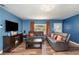 Bright living room boasts wood floors, comfortable seating, and large TV at 1125 Josephine St, Lakeland, FL 33815