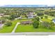 Expansive aerial view of a home with a manicured lawn and mature trees in a serene, country-like setting at 118 Caloosa Dr, Babson Park, FL 33827