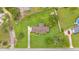 Overhead shot displaying the house, driveway, expansive green lawn, and the layout of the property at 118 Caloosa Dr, Babson Park, FL 33827