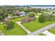 Aerial view of property showcasing a well-manicured lawn, mature trees, and the surrounding neighborhood at 118 Caloosa Dr, Babson Park, FL 33827