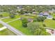 Aerial view showcasing the house, large lawn, surrounding trees, and additional structures on the property at 118 Caloosa Dr, Babson Park, FL 33827
