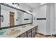 Bathroom with dual sinks, large mirror with vanity lighting, and tile flooring at 118 Caloosa Dr, Babson Park, FL 33827