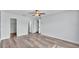 Bright bedroom featuring light-colored walls, a ceiling fan, and durable wood-look laminate flooring at 118 Caloosa Dr, Babson Park, FL 33827