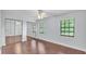 This bedroom offers hardwood floors and mirrored closet doors at 118 Caloosa Dr, Babson Park, FL 33827