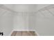 Walk-in closet with ample storage space and wire shelving, and durable wood-look laminate flooring at 118 Caloosa Dr, Babson Park, FL 33827
