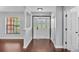 Welcoming entryway featuring hardwood floors, a decorative door, and neutral paint at 118 Caloosa Dr, Babson Park, FL 33827