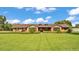 Charming single-story brick home featuring a manicured lawn and well-maintained landscaping at 118 Caloosa Dr, Babson Park, FL 33827