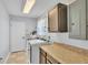 Bright laundry room with tile flooring and utility sink at 118 Caloosa Dr, Babson Park, FL 33827