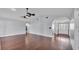 Open living room features a ceiling fan, and dark hardwood floors at 118 Caloosa Dr, Babson Park, FL 33827