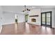 Open living room featuring a fireplace and dark hardwood floors at 118 Caloosa Dr, Babson Park, FL 33827