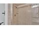 Updated tiled shower featuring glass door and updated fixtures at 118 Caloosa Dr, Babson Park, FL 33827