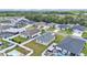 Aerial view of a suburban neighborhood featuring well-kept homes, lawns, and pools, surrounded by greenery at 122 St Thomas Dr, Mulberry, FL 33860