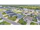 Overview of a well-planned suburban neighborhood featuring neat lawns, white fences, and a tranquil pond at 122 St Thomas Dr, Mulberry, FL 33860