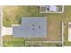 Top-down aerial view of a single-Gathering home with a gray roof, a green lawn, and a white fence at 122 St Thomas Dr, Mulberry, FL 33860
