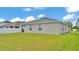 Home exterior showing a spacious backyard, perfect for entertaining and outdoor enjoyment at 122 St Thomas Dr, Mulberry, FL 33860