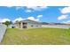 Expansive backyard with a well-maintained lawn and covered patio, ideal for outdoor activities at 122 St Thomas Dr, Mulberry, FL 33860