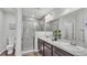 Modern bathroom with double sinks, a marble countertop, and a glass-enclosed shower at 122 St Thomas Dr, Mulberry, FL 33860