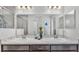 Bright bathroom featuring double sinks, a large mirror, and a glass-enclosed shower at 122 St Thomas Dr, Mulberry, FL 33860
