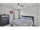 Bedroom featuring neutral walls, a ceiling fan, and a dark wood dresser with a baseball picture at 122 St Thomas Dr, Mulberry, FL 33860