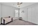 Bedroom showcasing a crib, a toddler chair, and a double door closet at 122 St Thomas Dr, Mulberry, FL 33860