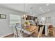 Bright dining area featuring a wooden table, seating for six, and a view into the kitchen at 122 St Thomas Dr, Mulberry, FL 33860