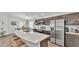 Well-lit kitchen with stainless steel appliances, a large island, and a view of the adjacent dining area at 122 St Thomas Dr, Mulberry, FL 33860