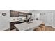 Modern kitchen with stainless steel appliances, dark cabinets, and a large island with seating at 122 St Thomas Dr, Mulberry, FL 33860