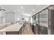 Spacious kitchen featuring stainless appliances, an island with seating, and an open layout to the living room at 122 St Thomas Dr, Mulberry, FL 33860