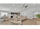 Open-concept living room and kitchen area with ample natural light and views of the dining area at 122 St Thomas Dr, Mulberry, FL 33860