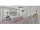 Serene main bedroom featuring a comfortable bed with drawers, two windows, and stylish decor at 122 St Thomas Dr, Mulberry, FL 33860