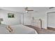 Bright main bedroom featuring a queen bed, neutral tones, and an elegant dresser at 122 St Thomas Dr, Mulberry, FL 33860