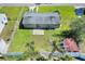 This aerial shot showcases the property's backyard with a patio and the surrounding neighborhood at 124 Carolyn Dr, Lakeland, FL 33803