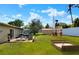 The spacious backyard features lush grass, a sandbox, and a playground set, perfect for outdoor activities and relaxation at 124 Carolyn Dr, Lakeland, FL 33803