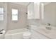 Well-lit bathroom with a bathtub and a sink with white cabinets at 124 Carolyn Dr, Lakeland, FL 33803