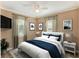 Inviting bedroom with a queen bed, soft lighting, and neutral-toned walls at 124 Carolyn Dr, Lakeland, FL 33803