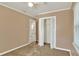 Cozy bedroom featuring a ceiling fan, neutral tones, and a large closet space at 124 Carolyn Dr, Lakeland, FL 33803