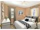 Comfortable bedroom featuring neutral tones, a ceiling fan, and two windows at 124 Carolyn Dr, Lakeland, FL 33803