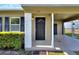 Inviting front entrance with a dark front door and covered carport at 124 Carolyn Dr, Lakeland, FL 33803