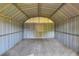 The interior of the storage shed has a metal frame, metal walls, and a gravel floor at 124 Carolyn Dr, Lakeland, FL 33803