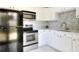 Efficient kitchen featuring stainless steel appliances and white cabinetry at 124 Carolyn Dr, Lakeland, FL 33803