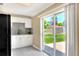 Bright kitchen with stainless steel appliances and sliding door access to the backyard at 124 Carolyn Dr, Lakeland, FL 33803