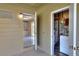 An interior view of a laundry area, showing an open doorway to a kitchen with white tile flooring and white cabinets at 124 Carolyn Dr, Lakeland, FL 33803